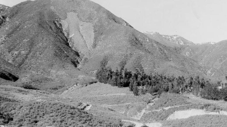 It's a black and white photo showing a mountainous landscape with dense vegetation.