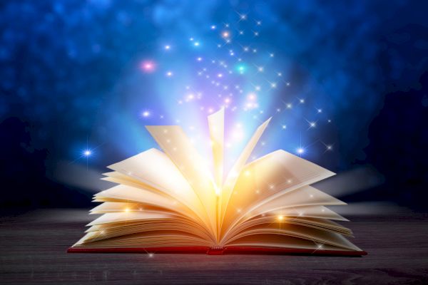 An open book with glowing lights and sparkles on a dark background.