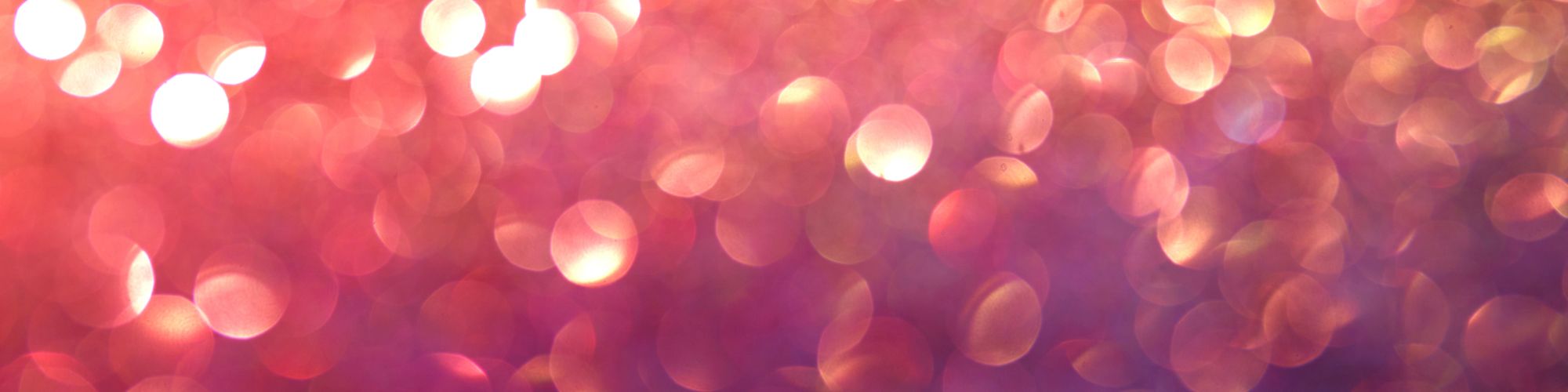 The image shows an abstract background with pink and orange bokeh lights, creating a soft and dreamy effect.
